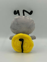 Load image into Gallery viewer, Little grey monster plush with yellow eyes and black stripes on his body. He has long thin black antenna and a yellow coin on his back!