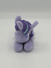 Load image into Gallery viewer, Purple horse plush laying on belly with purple star and black equals sign on flank and purple with blue stripe hair. Eye is purple.
