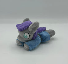 Load image into Gallery viewer, Grey horse plush laying on belly with purple hair. Eye is blue. Wears a blue dress with a grey belt
