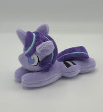 Load image into Gallery viewer, Purple horse plush laying on belly with purple star and black equals sign on flank and purple with blue stripe hair. Eye is purple.
