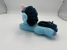 Load image into Gallery viewer, Blue horse plush laying on belly with blue yarn hair. Eye is green. Has a pink horn 
