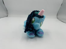 Load image into Gallery viewer, Blue horse plush laying on belly with blue yarn hair. Eye is green. Has a pink horn 
