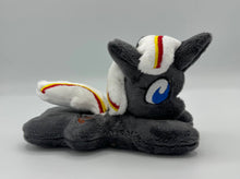 Load image into Gallery viewer, Grey horse plush laying on belly with brown bird on flank and white hair with yellow and red stripe. Eye is blue.
