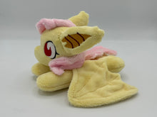 Load image into Gallery viewer, Yellow horse laying on belly with yellow bat wings and big yellow and gold bat ears. Has pink hair. Has red eyes. Has pink bats on flank. 
