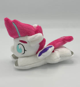 White horse plush laying on belly with pink lightning bolt on flank and pink with blue stripe hair. Eye is blue. Has purple tipped wings and silver hooves.