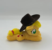 Load image into Gallery viewer, Orange horse plush laying on belly with red apples on flank and yellow hair with red hair ribbons. Eye is green. Wears a brown hat.
