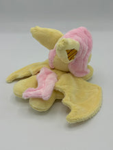 Load image into Gallery viewer, Yellow horse laying on belly with yellow bat wings and big yellow and gold bat ears. Has pink hair. Has red eyes. Has pink bats on flank. 
