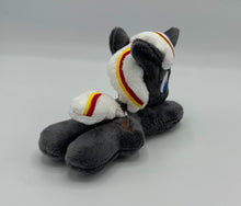 Load image into Gallery viewer, Grey horse plush laying on belly with brown bird on flank and white hair with yellow and red stripe. Eye is blue.
