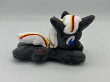 Load image into Gallery viewer, Grey horse plush laying on belly with brown bird on flank and white hair with yellow and red stripe. Eye is blue.
