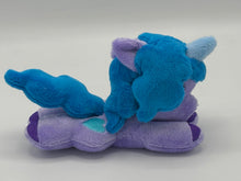 Load image into Gallery viewer, Purple horse plush laying on belly with blue heart on flank and blue hair. Eye is maroon.
