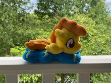 Load image into Gallery viewer, Blue body with yellow head horse plush laying on belly with yellow zigzag on flank and feet and has orange hair. Eye is brown.
