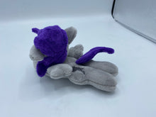 Load image into Gallery viewer, Grey horse plush laying on belly with silver lightning bolt on flank and purple hair. Eye is purple.
