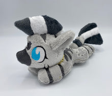 Load image into Gallery viewer, A zebra plush laying on belly. The coat is grey with black stripes. There is a grey sun design on the flank. She has a dark grey muzzle. Hair is white and grey stripes. Eye is blue. She has a gold chain around her neck. 
