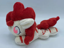 Load image into Gallery viewer, Cream colored horse plush with red stripes laying on belly with red candy canes shaped like a heart on flank and red hair. Eye is pink.
