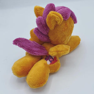 Orange horse plush laying on belly with purple and pink crest on flank and purple hair. Eye is purple.