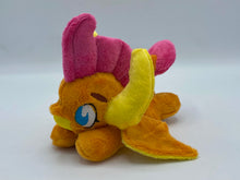 Load image into Gallery viewer, Orange dragon plush laying on belly. She is orange with a yellow belly. Her wings are orange and yellow. Her horns are yellow. She has pink hair. Her tail is orange and yellow with a pink tip. Her mouth is yellow. Her eyes are blue. She has brown eyebrows. 
