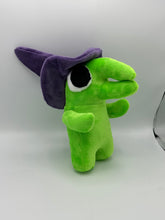 Load image into Gallery viewer, A green monster plush that has a huge mouth and nose. He has a big eye and wears a purple witch hat. 
