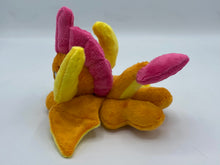 Load image into Gallery viewer, Orange dragon plush laying on belly. She is orange with a yellow belly. Her wings are orange and yellow. Her horns are yellow. She has pink hair. Her tail is orange and yellow with a pink tip. Her mouth is yellow. Her eyes are blue. She has brown eyebrows. 
