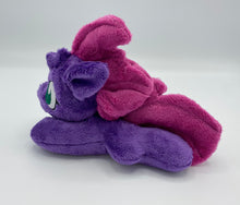 Load image into Gallery viewer, Purple colored horse plush laying on belly with maroon Mohawk hair. Eye is green. 
