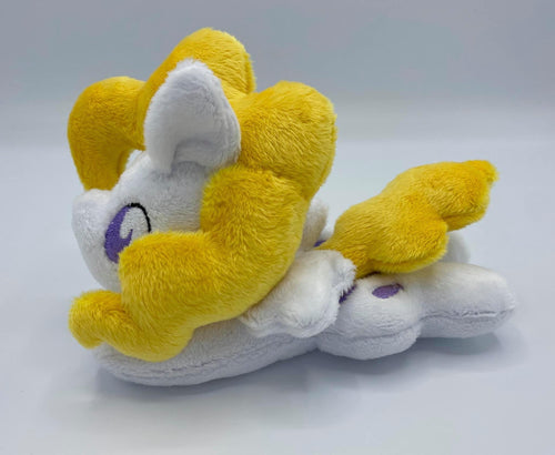 White horse plush laying on belly with purple balloons on flank and yellow hair. Eye is purple.