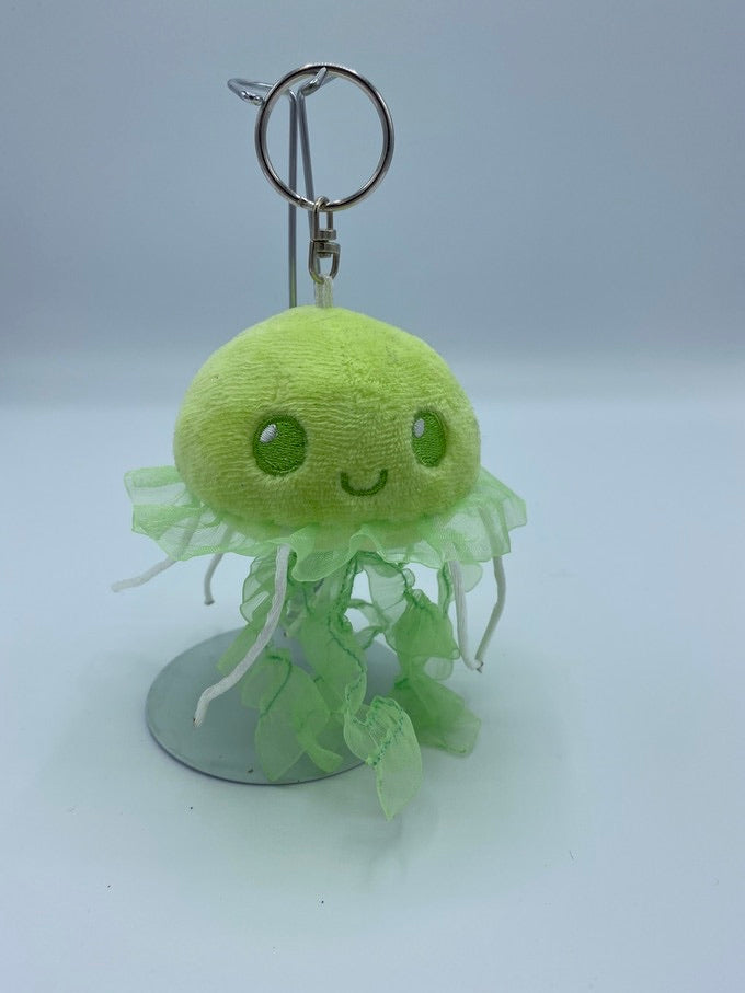 Green jellyfish that has ribbons for tentacles